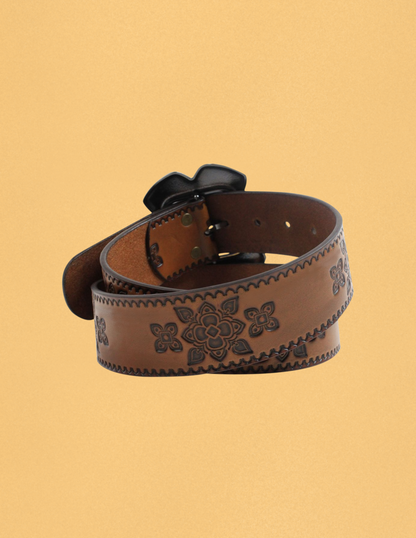 Brown leather belt with floral patterns on a beige background